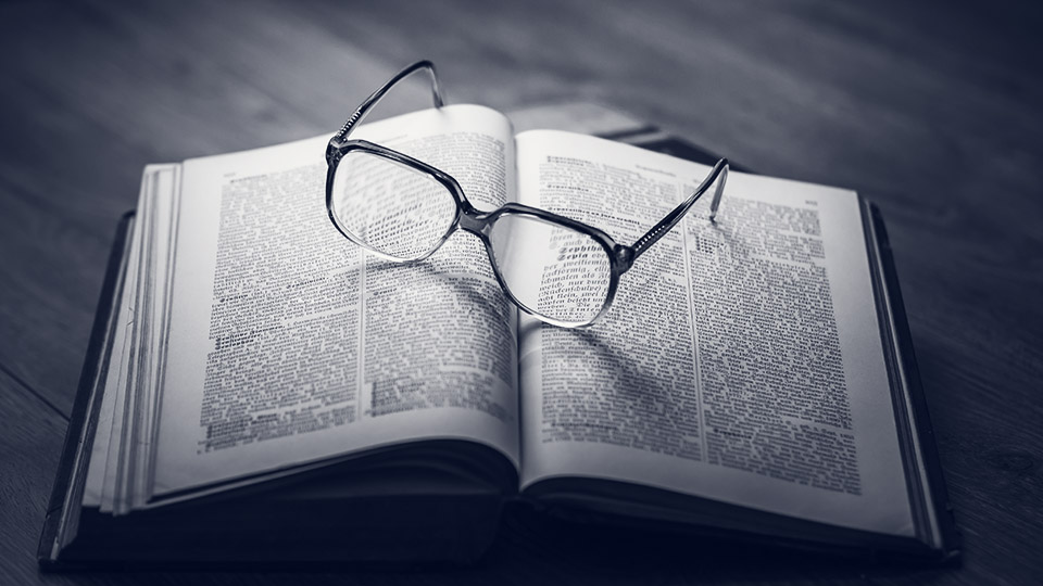 Open book with glasses