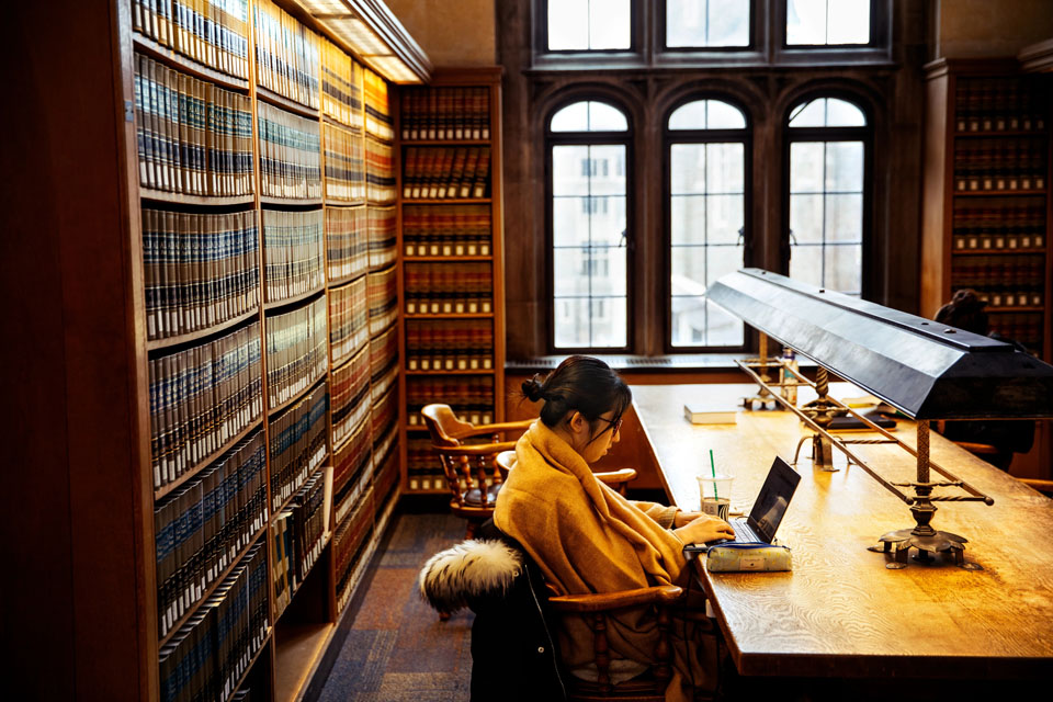 A law student finds a quiet place to study in the Myron Taylor Hall library.